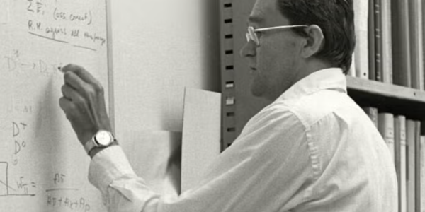 James Bjorken writing at a chalkboard