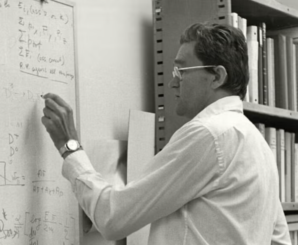 James Bjorken writing at a chalkboard